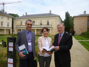 The Hon Michael Kirby AC CMG (right) presenting copies of Torts - The Laws of Australia (3rd ed) to Professor Sarah Worthington (centre) and Professor Andrew Robertson (left) at Downing College, University of Cambridge.